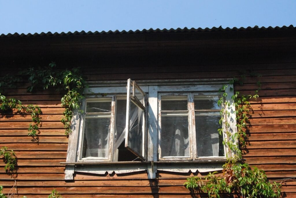 Indian tourism Rustic wooden homestay with old windows and climbing plants